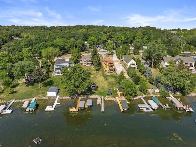 aerial view with a water view and a forest view