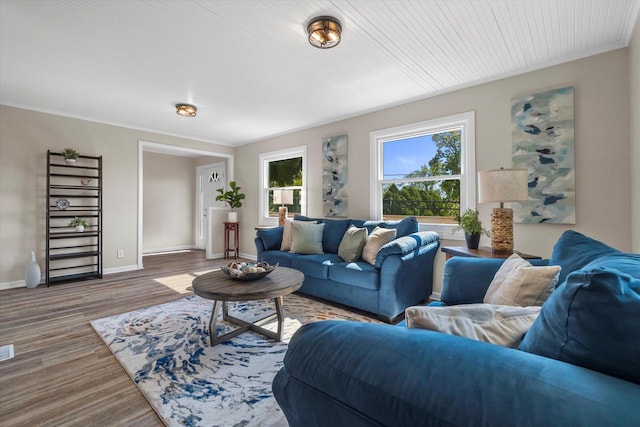 living area with baseboards and wood finished floors