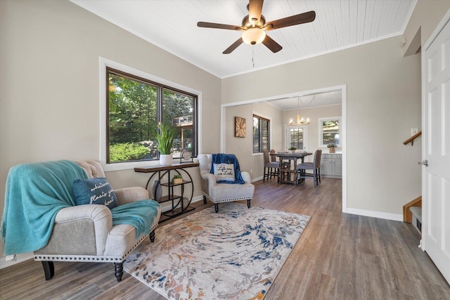 sitting room featuring ornamental molding, stairs, baseboards, and wood finished floors