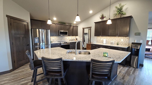 kitchen featuring appliances with stainless steel finishes, dark wood-type flooring, a sink, and dark brown cabinets