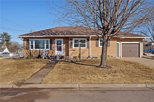 ranch-style house featuring a garage, driveway, and a front lawn