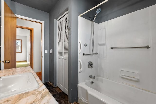 bathroom with bathtub / shower combination and a sink