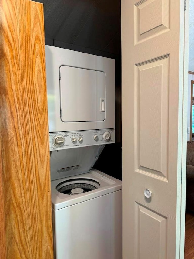 washroom featuring laundry area and stacked washer / dryer