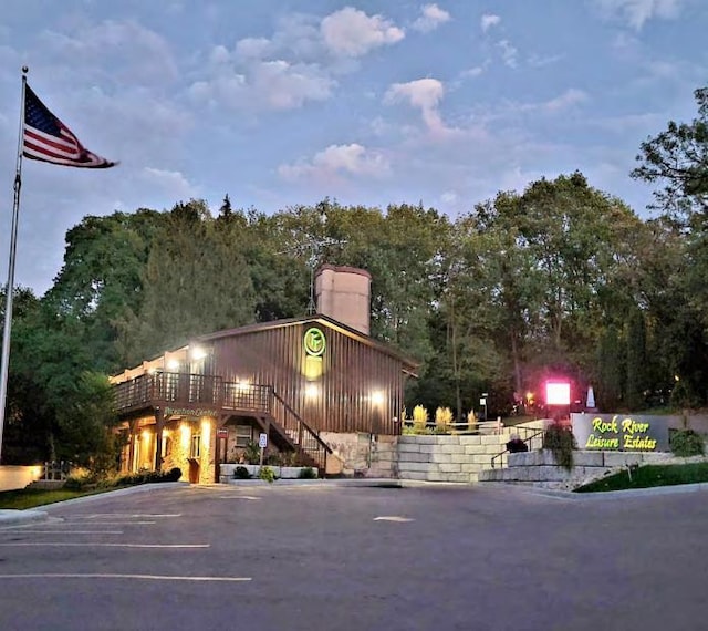 exterior space featuring uncovered parking and stairway