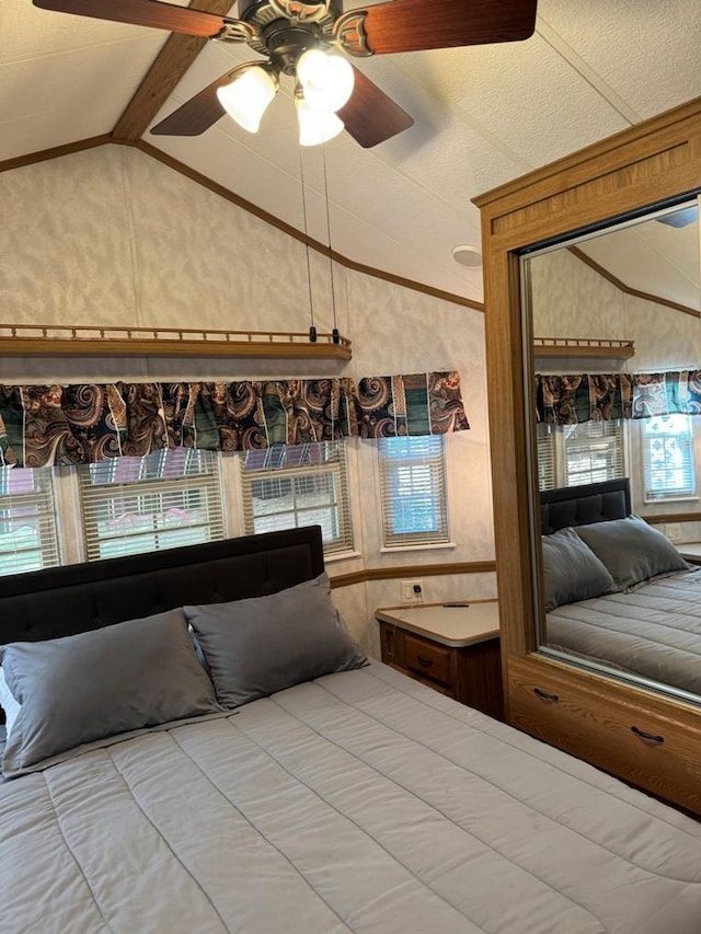 unfurnished bedroom with vaulted ceiling with beams and a ceiling fan