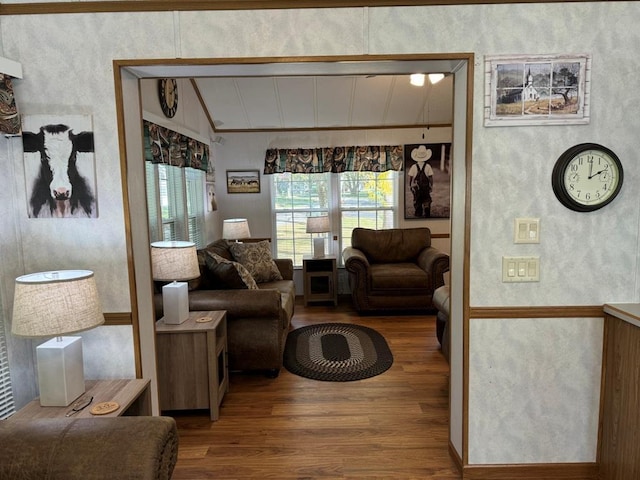 living room with vaulted ceiling and wood finished floors