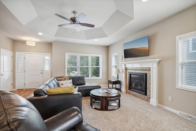 living area with recessed lighting, a glass covered fireplace, a ceiling fan, and baseboards