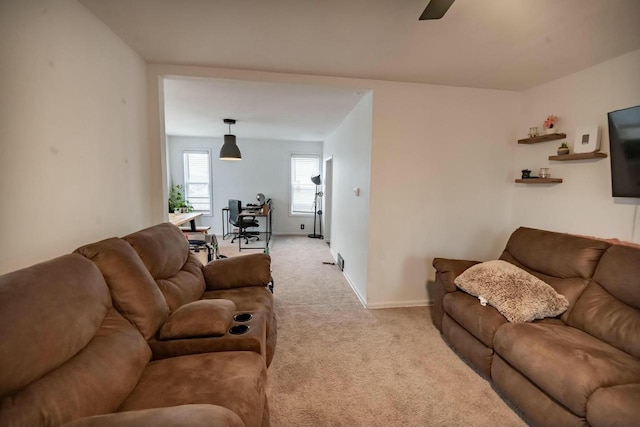 living room featuring baseboards and light colored carpet