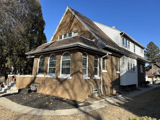 view of property exterior with brick siding