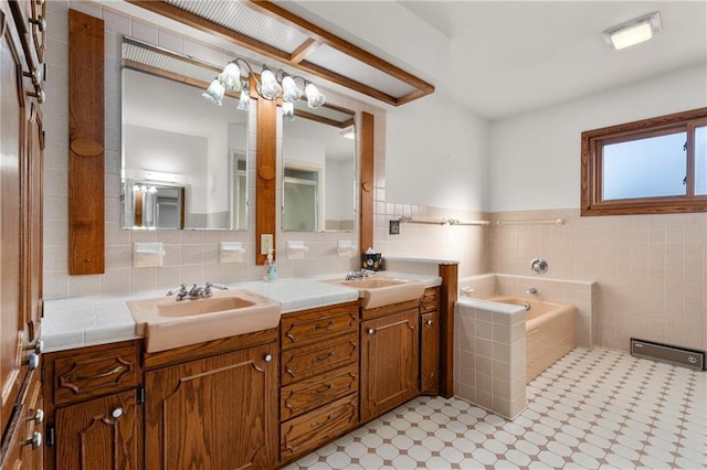 full bath featuring double vanity, a sink, a bath, and tile walls