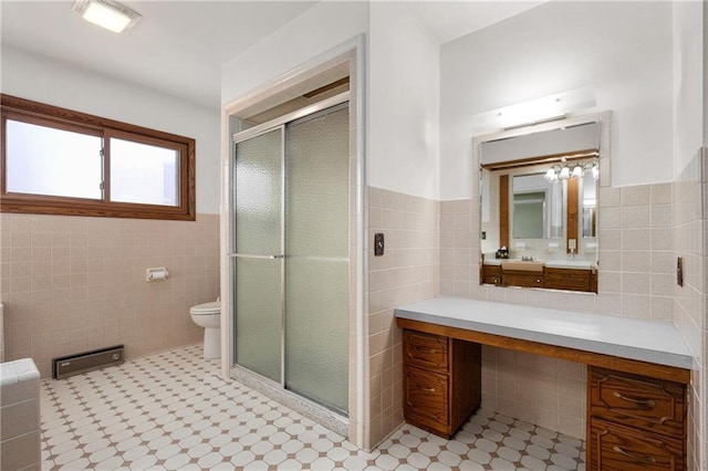 full bath featuring visible vents, toilet, vanity, a shower stall, and tile walls