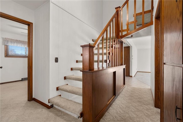 staircase featuring carpet