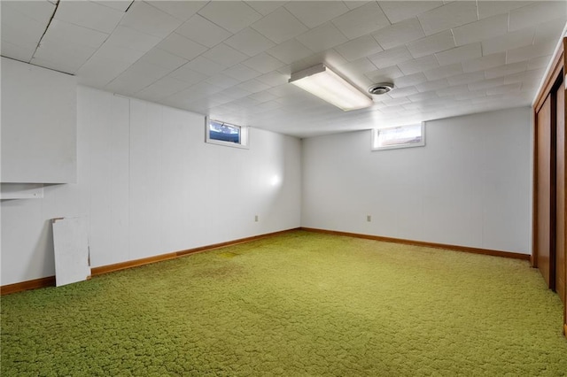 basement featuring carpet, visible vents, and baseboards