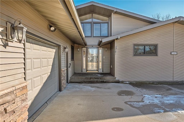 view of exterior entry featuring an attached garage