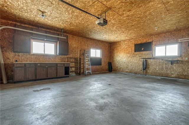 interior space with a garage and unfinished concrete floors