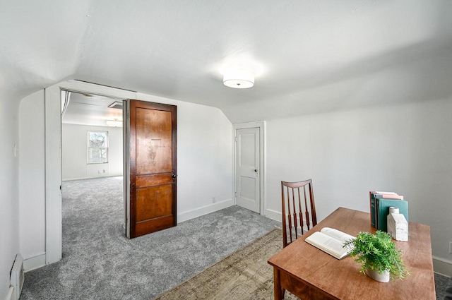 office space featuring a baseboard heating unit, carpet, lofted ceiling, and baseboards