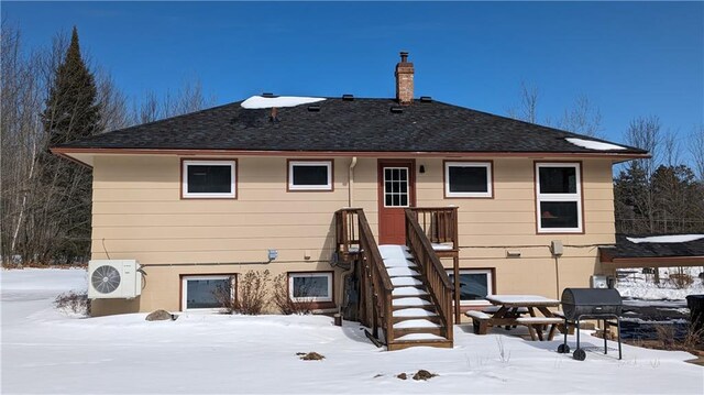 14091 W County Highway B, Hayward, WI 54843 - snow covered property with ac unit and a chimney