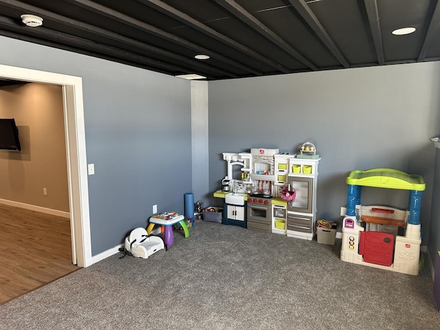 game room with carpet flooring and baseboards