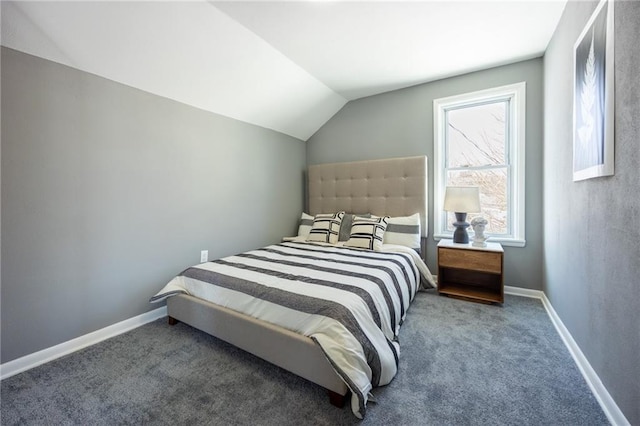 bedroom featuring baseboards, lofted ceiling, and carpet