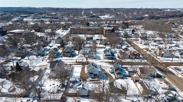 snowy aerial view featuring a residential view