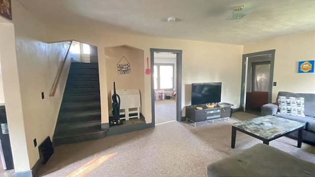 living room with carpet floors and stairway