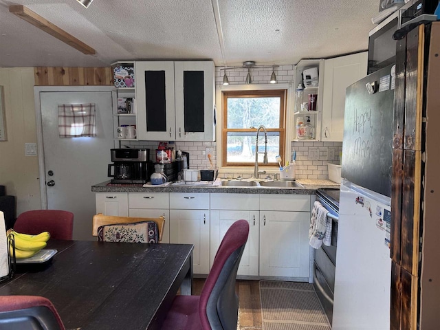 kitchen featuring electric range, a sink, white cabinetry, decorative backsplash, and open shelves