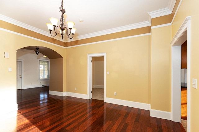 unfurnished room featuring arched walkways, crown molding, wood finished floors, and baseboards