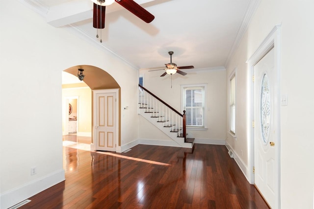 foyer with wood-type flooring, stairway, and ornamental molding