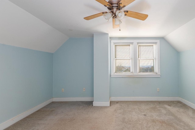 additional living space featuring lofted ceiling, light colored carpet, ceiling fan, and baseboards