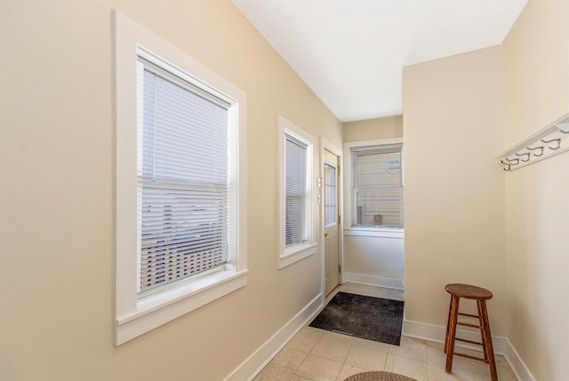 entryway with tile patterned flooring and baseboards