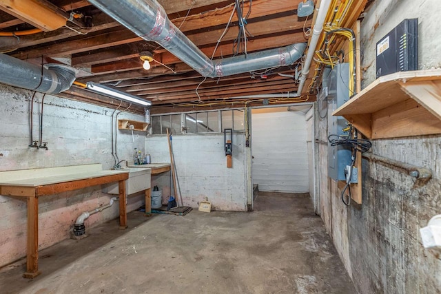 unfinished basement with a workshop area and a sink