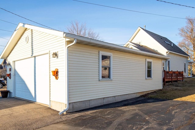 view of side of home featuring a garage