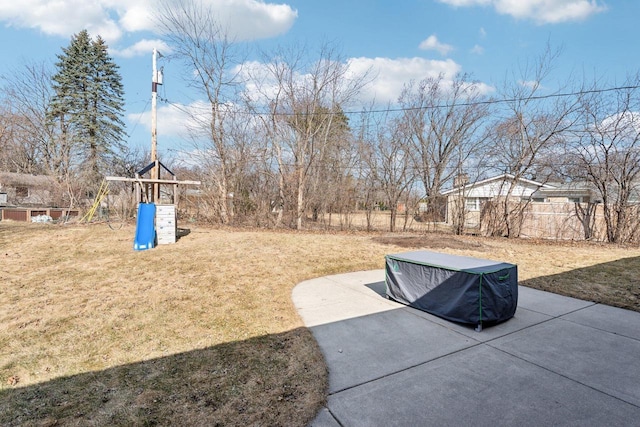 view of yard with a playground, a patio, and fence