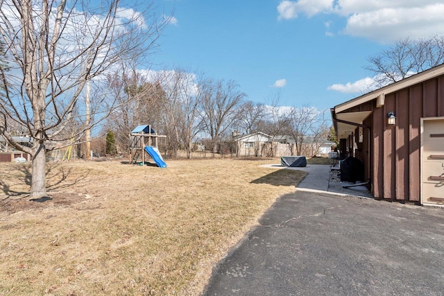 view of yard featuring a playground and fence