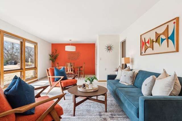 carpeted living area with baseboards