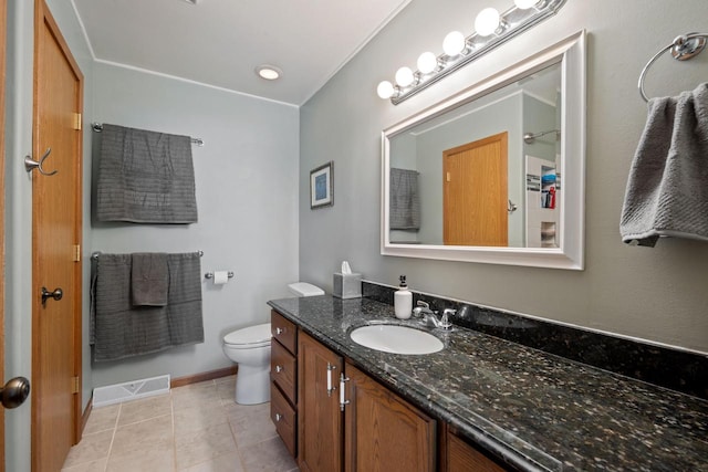 bathroom featuring vanity, baseboards, visible vents, tile patterned flooring, and toilet