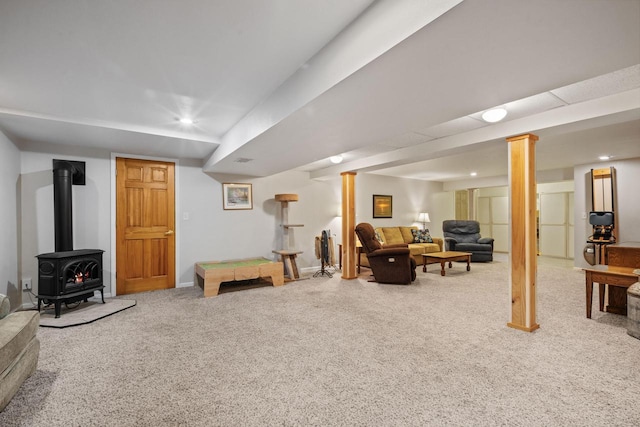 living room featuring recessed lighting, baseboards, a wood stove, and carpet