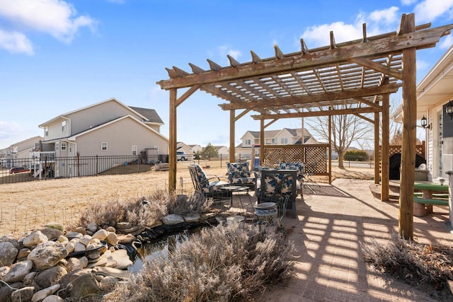 view of patio featuring fence, a pergola, and a residential view