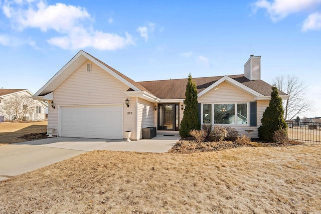 ranch-style house with fence, an attached garage, a shingled roof, a chimney, and concrete driveway