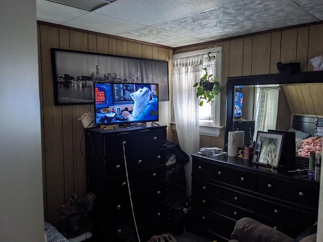 bedroom featuring wood walls