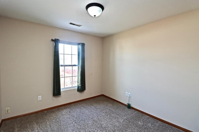 carpeted spare room with visible vents, a wealth of natural light, and baseboards