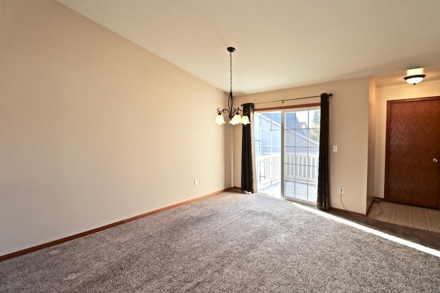 carpeted empty room with a notable chandelier, vaulted ceiling, and baseboards