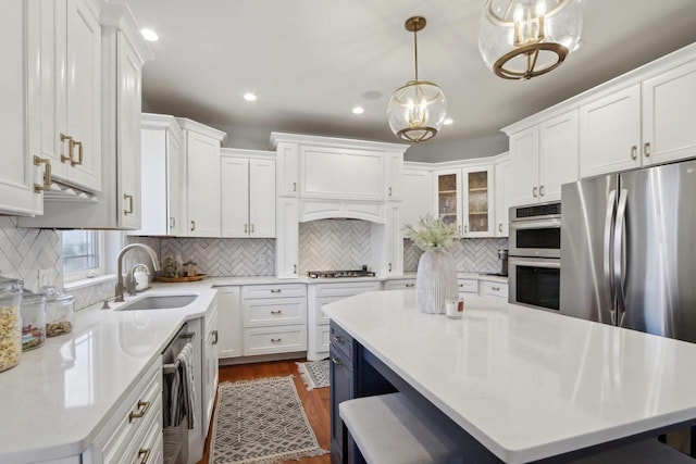 kitchen featuring a sink, appliances with stainless steel finishes, and white cabinetry