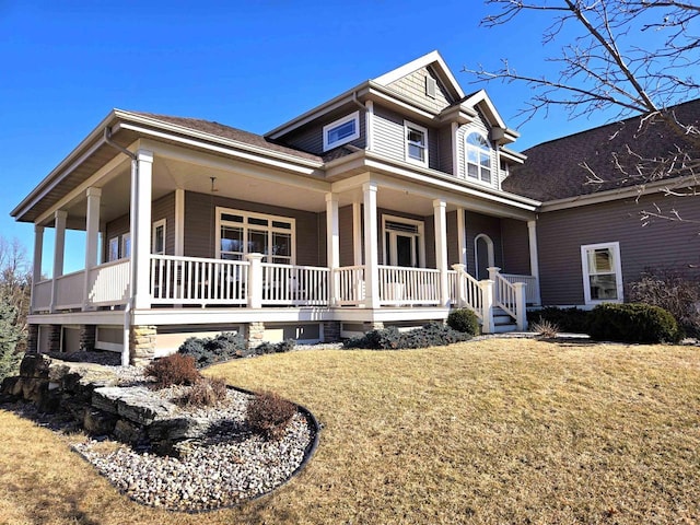 view of front of property featuring covered porch and a front lawn