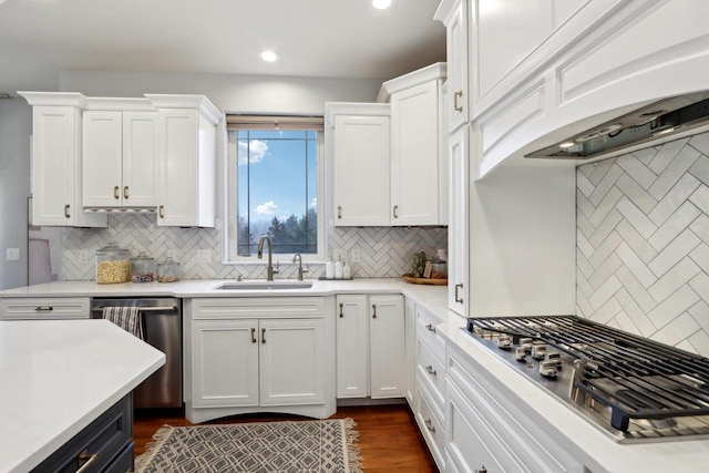 kitchen featuring white cabinetry, light countertops, stainless steel appliances, and a sink