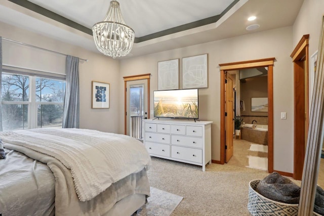 bedroom with a tray ceiling, a notable chandelier, light colored carpet, and baseboards