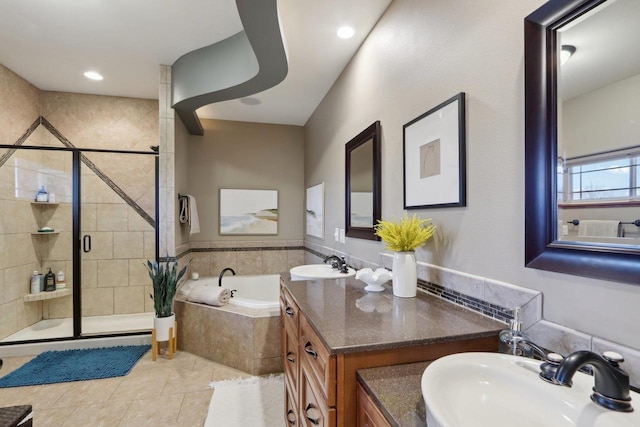 full bath featuring tile patterned flooring, a shower stall, a garden tub, and a sink