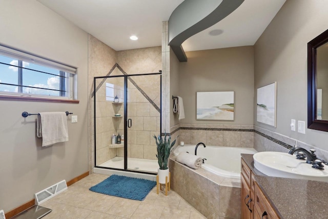 full bath with vanity, baseboards, visible vents, a stall shower, and a bath