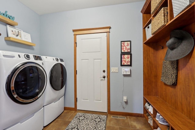 clothes washing area with visible vents, baseboards, laundry area, tile patterned floors, and independent washer and dryer