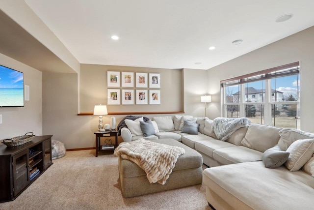 living area featuring light carpet, recessed lighting, and baseboards